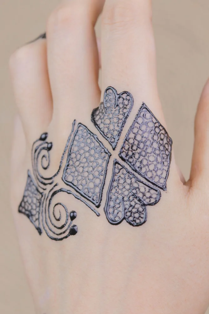 beautiful henna art back side of the hand